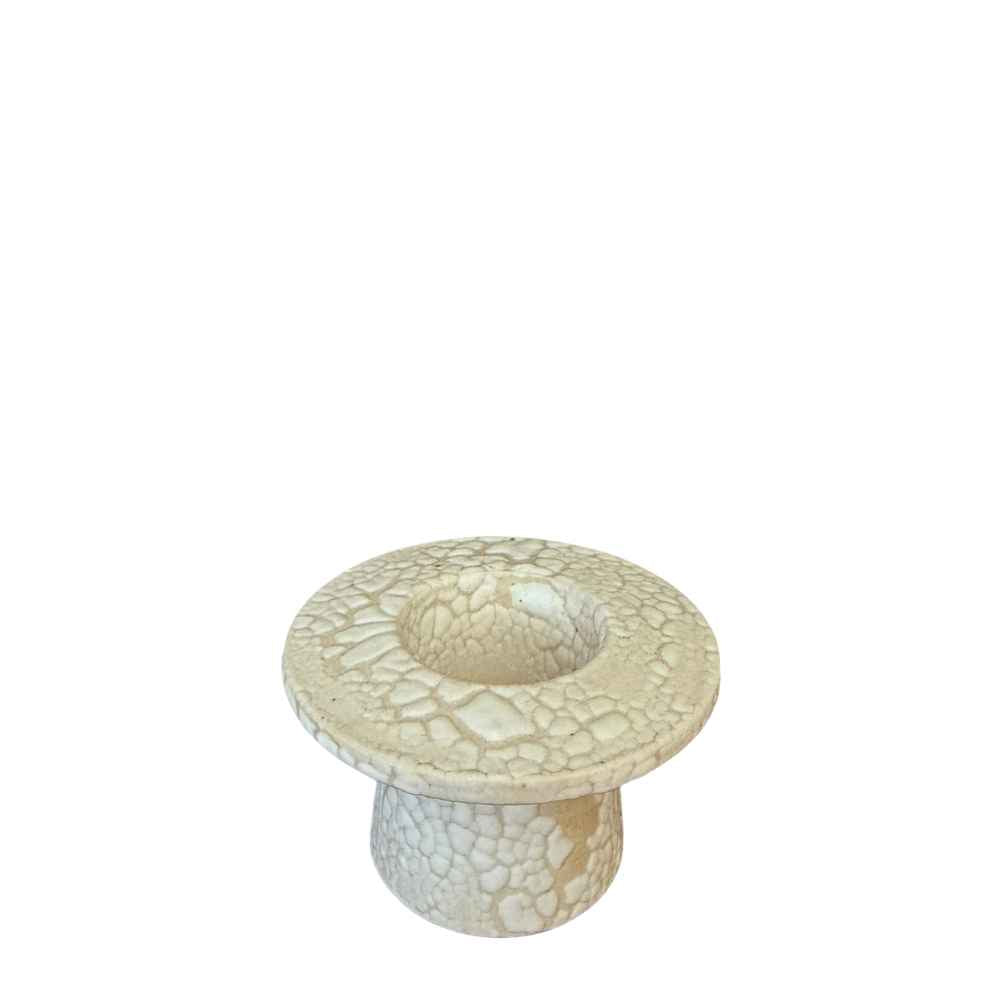 A small round ceramic candle holder with a textured, crackled glaze in a warm cream, set against a plain white background.