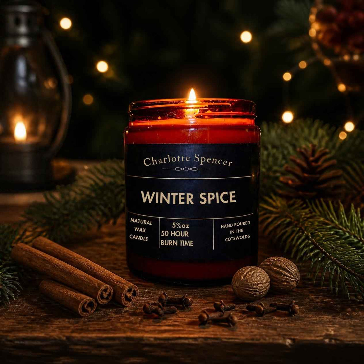 A Winter Spice candles by Charlotte Spencer in a brown glass jar with nutmeg, cinnamon and cloves.