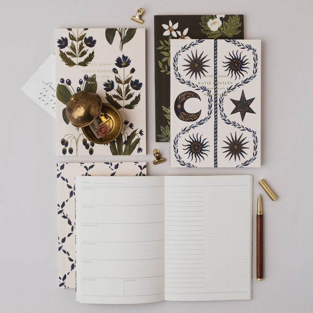 Blue Botanical A5 planner open to its undated weekly planning pages